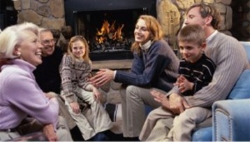 family-sitting-near-the-fireplace-in-a-living-room