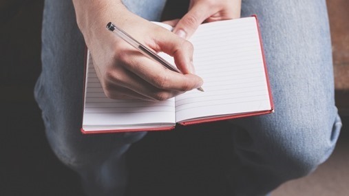 Man writing in notebook