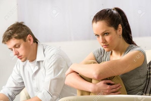 Unhappy-couple-sitting-on-couch-silently-after-argument