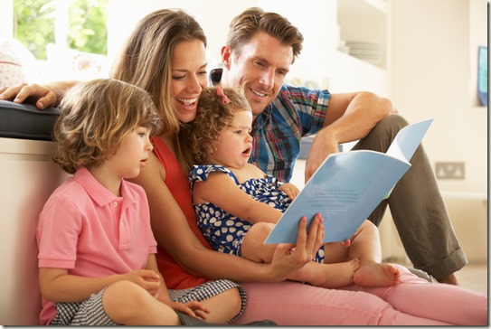 Parents Sitting With Children Reading Story Indoors