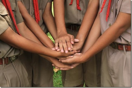 Boy scouts holding hand together in camp , strong concept about teamwork and cooperation, also refers to immigration and friendship.; Shutterstock ID 522627778